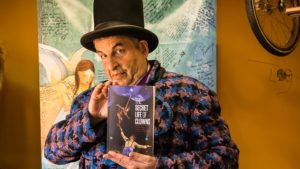 Jeff Raz holding a copy of his book The Secret Life of Clowns